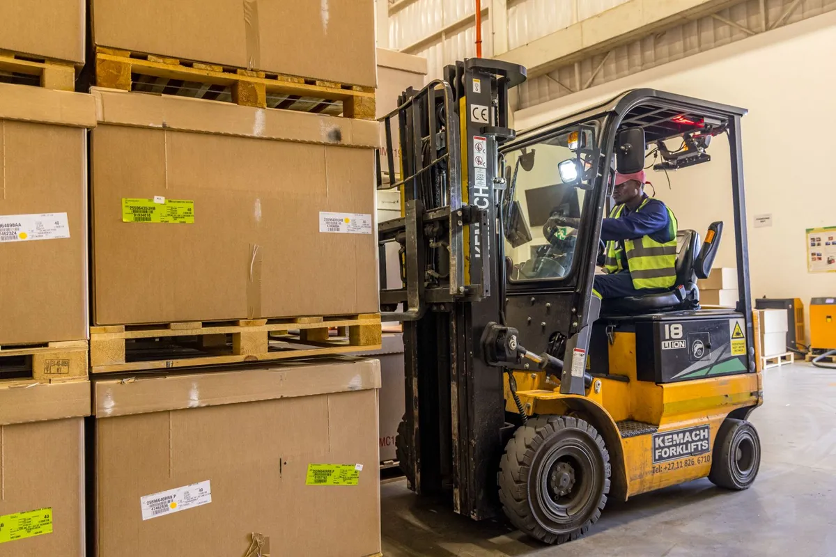 Forklift handling palletised automotive inventory